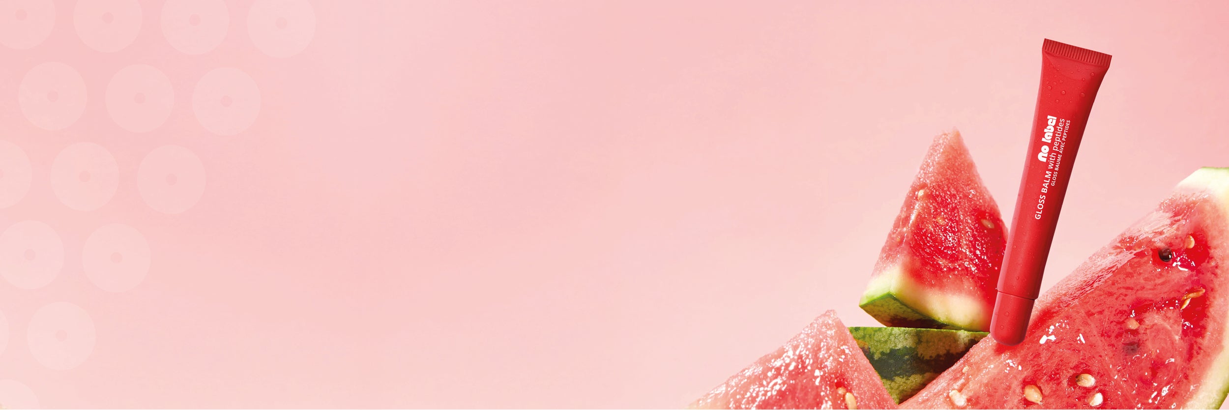Red lipbalm product with watermelon slices on a pink background